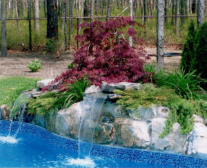 Backyard landscaping renovations inground pool with waterfall