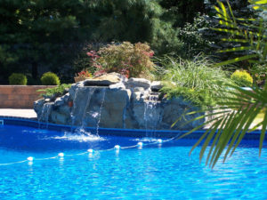 inground pool and waterfall