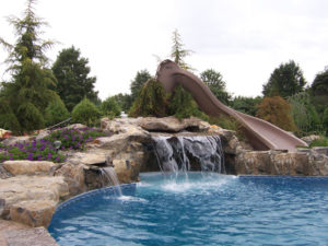 Backyard renovations inground pool with waterfall and slide